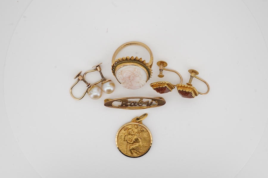 Two pairs of 9ct ear clips including cultured pearl, a 9ct 'Baby' brooch, a 9ct and cameo set ring and a yellow metal pendant, gross weight 14.6 grams. Condition - poor to fair